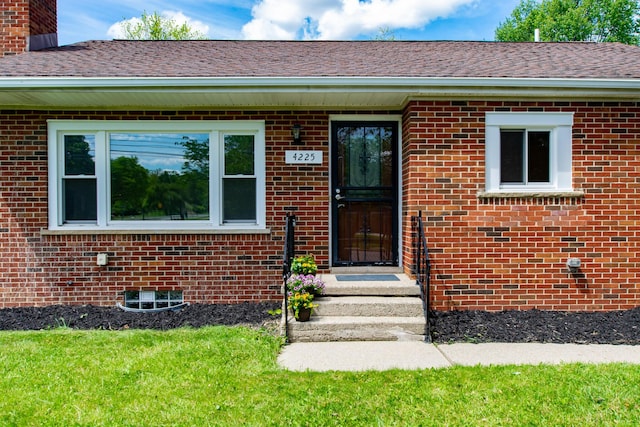 4225 Central Blvd, Ann Arbor, MI 48108 - doorway to property featuring brick siding, a chimney, and roof with shingles