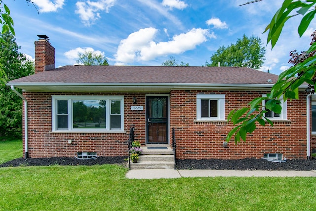 4225 Central Blvd, Ann Arbor, MI 48108 - view of front facade with brick siding, a chimney, a front yard, and a shingled roof