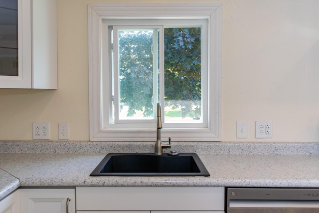 4225 Central Blvd, Ann Arbor, MI 48108 - kitchen featuring stainless steel dishwasher, a sink, white cabinetry, and glass insert cabinets