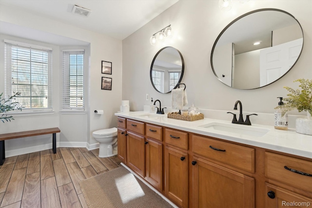 177 Summer Shade Dr, Howell, MI 48843 - bathroom featuring double vanity, healthy amount of natural light, and wood finish floors