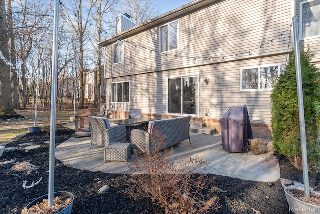 177 Summer Shade Dr, Howell, MI 48843 - rear view of property with a chimney and a patio area