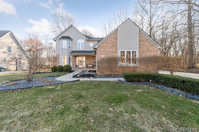 177 Summer Shade Dr, Howell, MI 48843 - back of house with brick siding and a lawn
