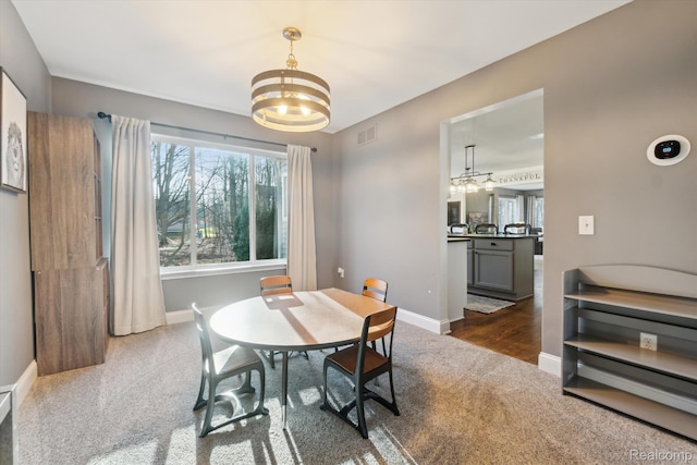 177 Summer Shade Dr, Howell, MI 48843 - carpeted dining area featuring a chandelier and baseboards