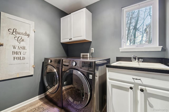 177 Summer Shade Dr, Howell, MI 48843 - laundry area featuring cabinet space, washing machine and dryer, plenty of natural light, and wood finished floors