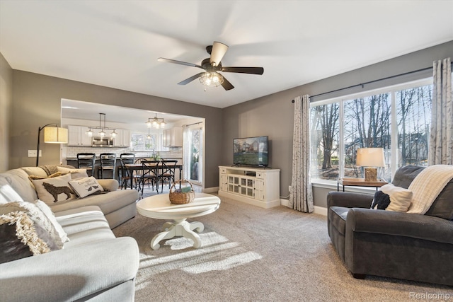 177 Summer Shade Dr, Howell, MI 48843 - living area with a ceiling fan, light carpet, and baseboards
