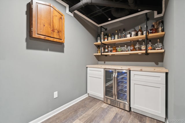 177 Summer Shade Dr, Howell, MI 48843 - indoor dry bar featuring wine cooler, light wood-style flooring, and baseboards
