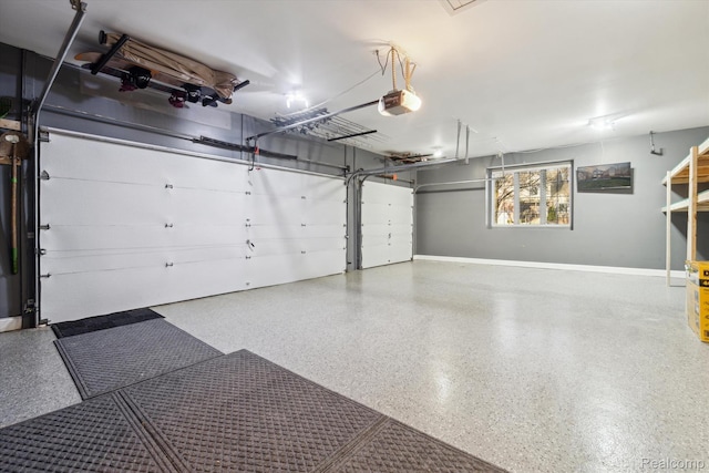 177 Summer Shade Dr, Howell, MI 48843 - garage with a garage door opener and baseboards
