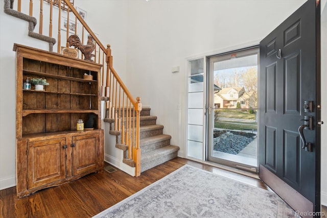177 Summer Shade Dr, Howell, MI 48843 - foyer featuring stairs, dark wood finished floors, baseboards, and a high ceiling