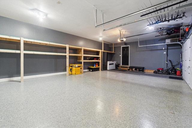 177 Summer Shade Dr, Howell, MI 48843 - garage with a garage door opener and baseboards