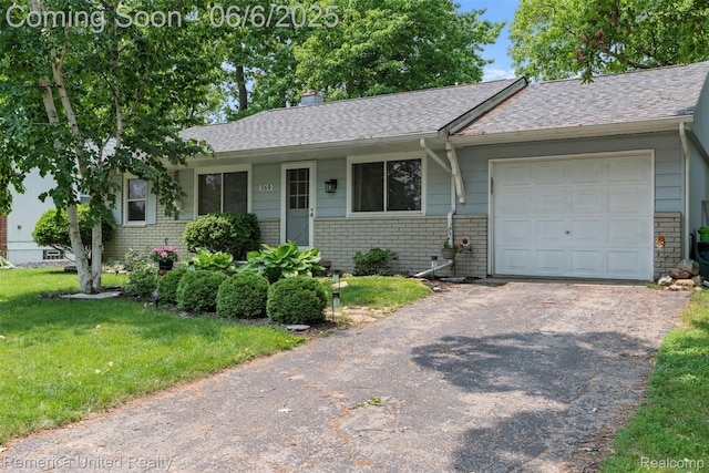 569 Lyon Blvd, South Lyon, MI 48178 - ranch-style house with brick siding, driveway, roof with shingles, and a front yard