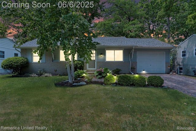 569 Lyon Blvd, South Lyon, MI 48178 - ranch-style house featuring brick siding, driveway, an attached garage, and a front lawn