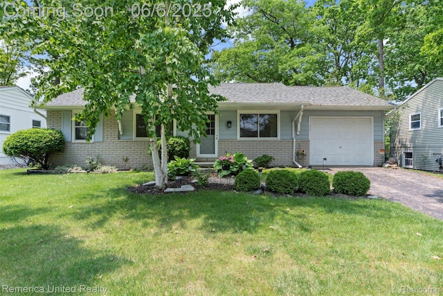 569 Lyon Blvd, South Lyon, MI 48178 - view of front of property with brick siding, driveway, a garage, and a front yard