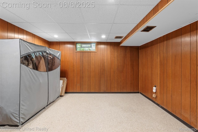 569 Lyon Blvd, South Lyon, MI 48178 - below grade area featuring a drop ceiling, wooden walls, and recessed lighting