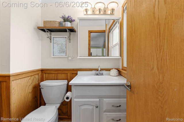 569 Lyon Blvd, South Lyon, MI 48178 - half bathroom with toilet, vanity, and wainscoting