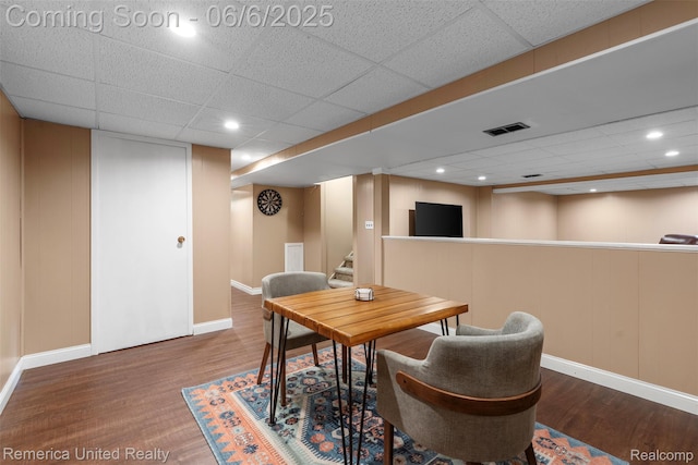 569 Lyon Blvd, South Lyon, MI 48178 - dining space with a drop ceiling, wood finished floors, baseboards, a decorative wall, and stairway