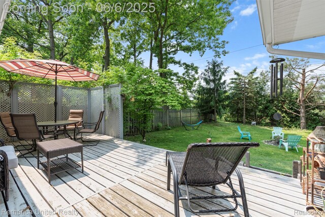 569 Lyon Blvd, South Lyon, MI 48178 - wooden terrace featuring outdoor dining space and view of scattered trees