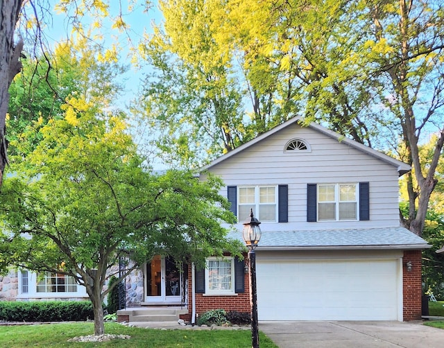 18830 San Quentin Dr, Lathrup Village, MI 48076 - view of front of house featuring an attached garage, driveway, brick siding, and a shingled roof