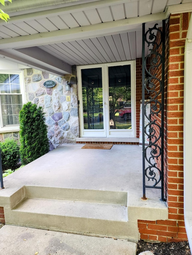18830 San Quentin Dr, Lathrup Village, MI 48076 - property entrance with a porch and stone siding