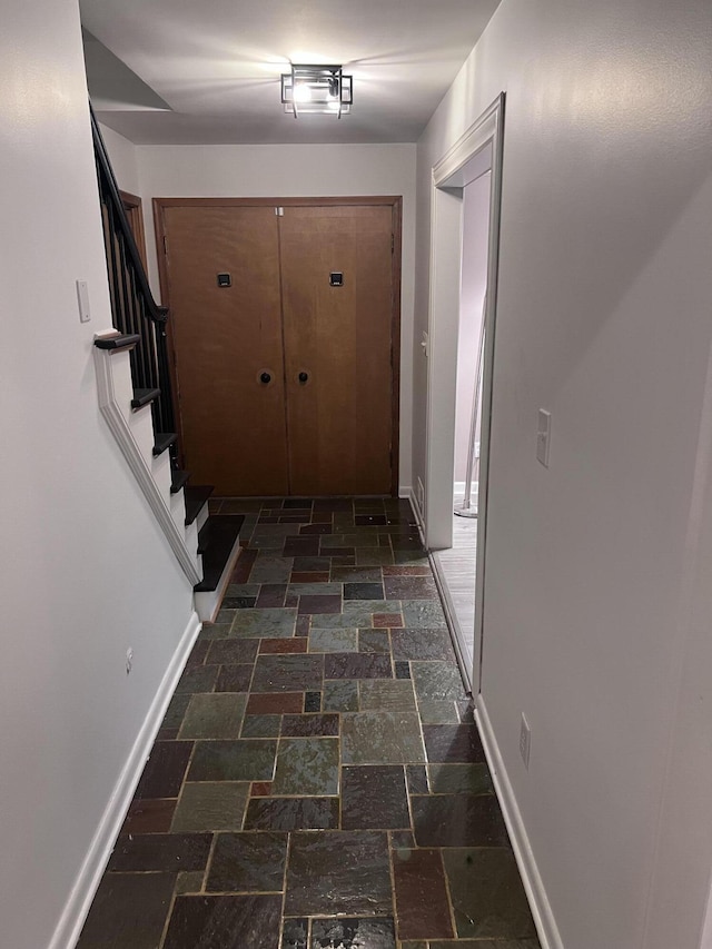 18830 San Quentin Dr, Lathrup Village, MI 48076 - hall with stone tile flooring, baseboards, and stairway