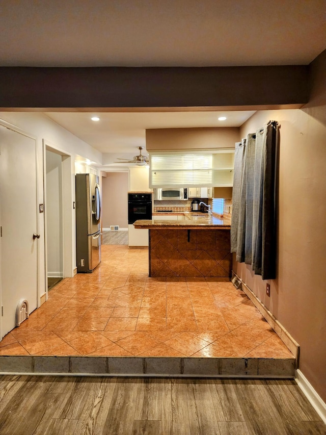 18830 San Quentin Dr, Lathrup Village, MI 48076 - kitchen with appliances with stainless steel finishes, a peninsula, baseboards, recessed lighting, and white cabinets