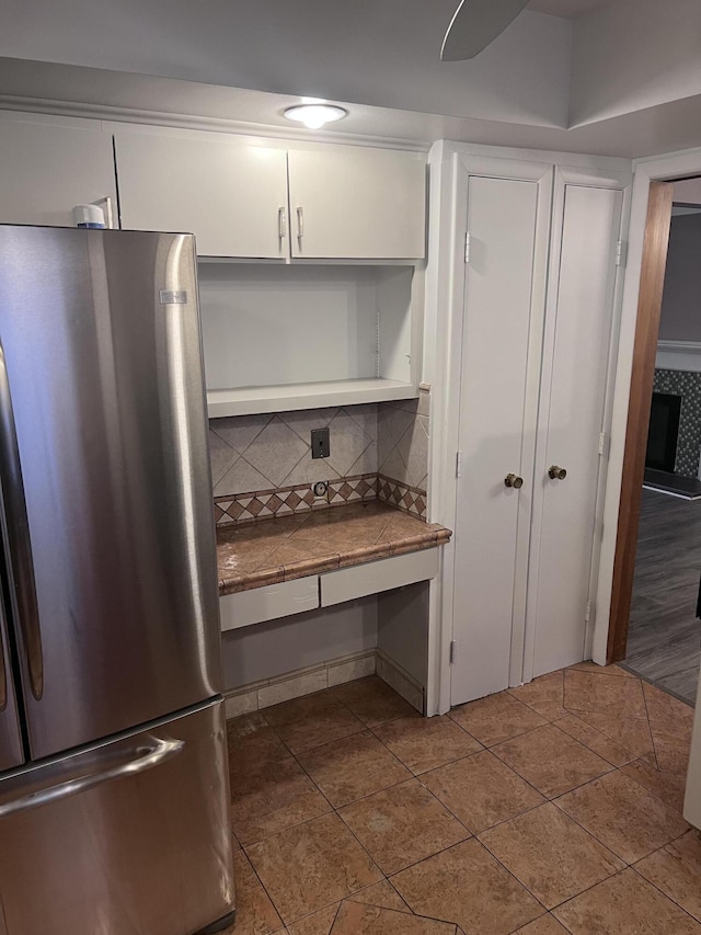 18830 San Quentin Dr, Lathrup Village, MI 48076 - kitchen with freestanding refrigerator, backsplash, white cabinets, and tile counters