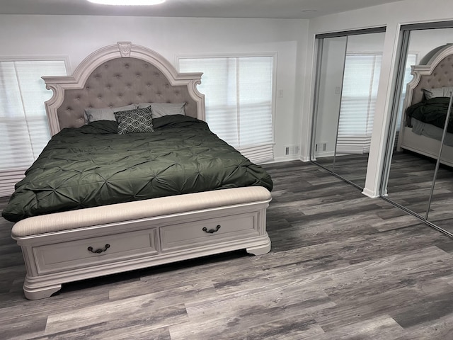 18830 San Quentin Dr, Lathrup Village, MI 48076 - bedroom with multiple closets, dark wood-type flooring, and baseboards