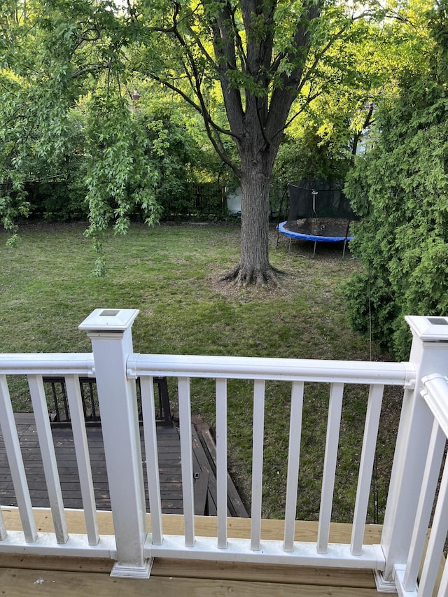 18830 San Quentin Dr, Lathrup Village, MI 48076 - view of green lawn with a trampoline and a wooden deck