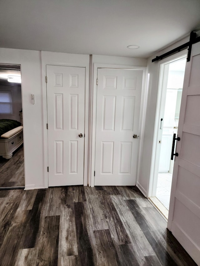 18830 San Quentin Dr, Lathrup Village, MI 48076 - entrance foyer featuring a barn door, wood finished floors, and baseboards