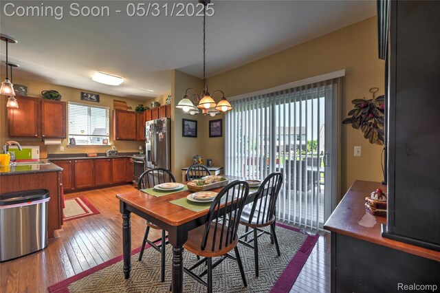 28329 Cottage Ln, New Hudson, MI 48165 - dining room featuring light wood finished floors and a chandelier