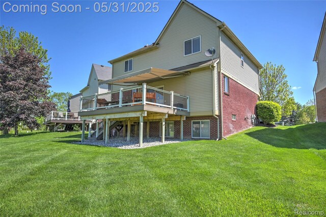 28329 Cottage Ln, New Hudson, MI 48165 - rear view of house featuring a deck, a yard, and brick siding