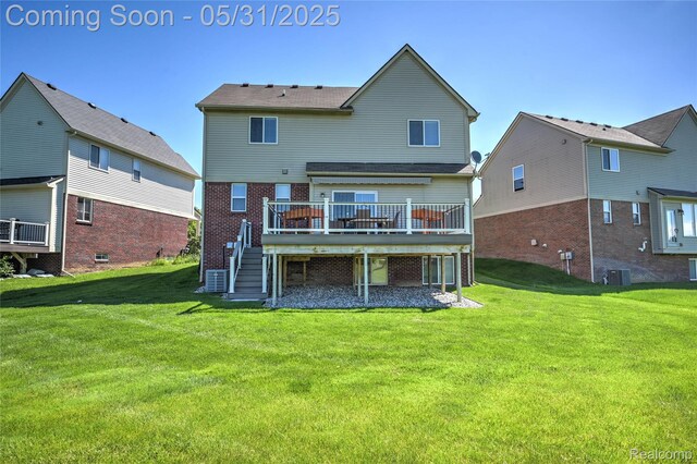 28329 Cottage Ln, New Hudson, MI 48165 - rear view of house featuring a deck, brick siding, stairs, and a lawn