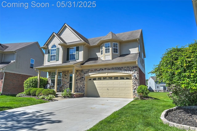 28329 Cottage Ln, New Hudson, MI 48165 - view of front of home with a garage, a front yard, concrete driveway, and stone siding