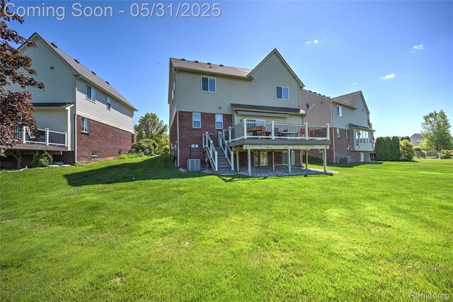28329 Cottage Ln, New Hudson, MI 48165 - rear view of house featuring a wooden deck, central AC, stairway, and a yard
