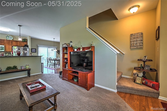 28329 Cottage Ln, New Hudson, MI 48165 - carpeted living room with stairs, baseboards, a chandelier, and wood finished floors