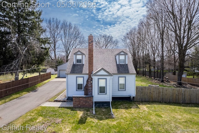 117 W Northrup St, Lansing, MI 48911 - cape cod home with a chimney, a detached garage, an outbuilding, and roof with shingles