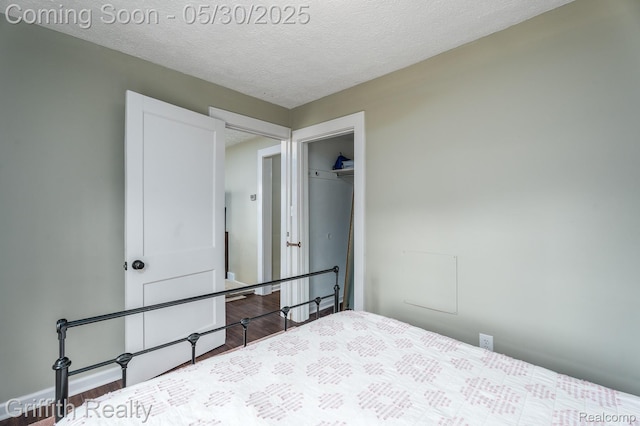 117 W Northrup St, Lansing, MI 48911 - bedroom with wood finished floors, a textured ceiling, and a closet