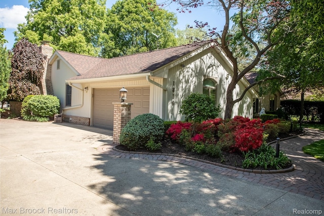 1816 Ledbury Dr, Bloomfield Hills, MI 48304 - view of front of property featuring an attached garage, driveway, a chimney, and roof with shingles