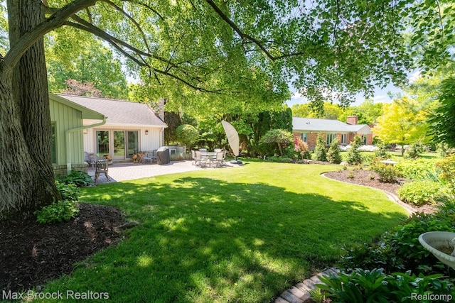 1816 Ledbury Dr, Bloomfield Hills, MI 48304 - view of green lawn with a patio area and french doors