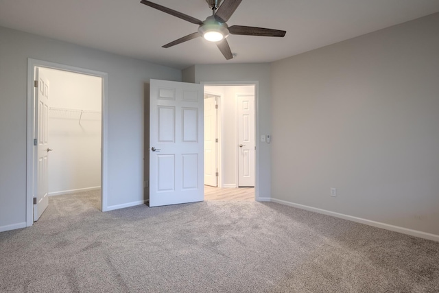 157 Hunters Ln NE, Rockford, MI 49341 - unfurnished bedroom with carpet floors, a spacious closet, and baseboards