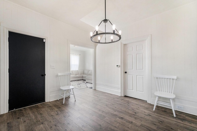 723 Baxter St SE, Grand Rapids, MI 49503 - spare room with dark wood-type flooring and a chandelier