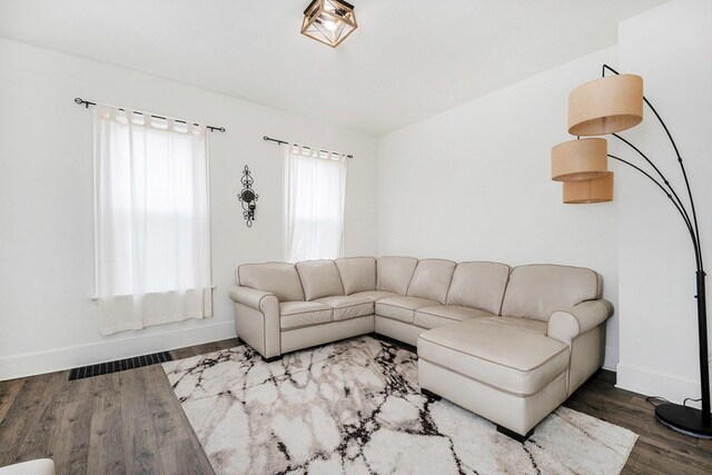 723 Baxter St SE, Grand Rapids, MI 49503 - living room with wood finished floors, baseboards, and lofted ceiling