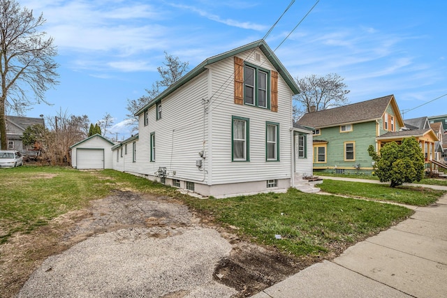 723 Baxter St SE, Grand Rapids, MI 49503 - view of front of home featuring dirt driveway, a garage, an outdoor structure, and a front yard