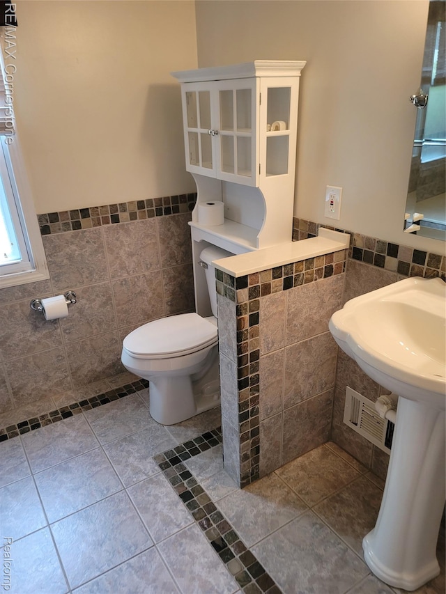 29751 Balmoral St, Garden City, MI 48135 - half bathroom with tile walls, toilet, wainscoting, and tile patterned floors