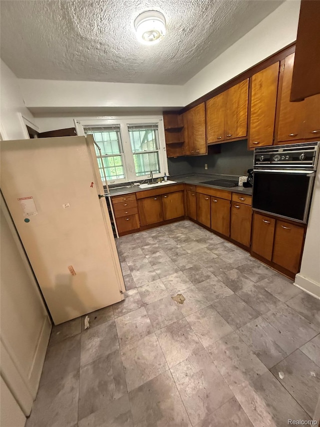 8071 Elgin St, Detroit, MI 48234 - kitchen featuring black appliances, brown cabinetry, open shelves, a sink, and a textured ceiling