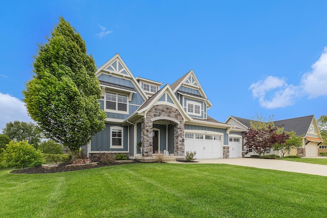 1506 Providence Cove Ct, Byron Center, MI 49315 - view of front of house with stone siding, board and batten siding, a front lawn, concrete driveway, and a garage