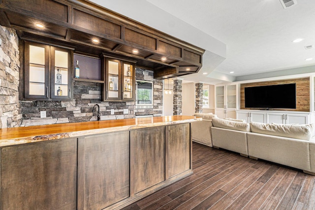 1506 Providence Cove Ct, Byron Center, MI 49315 - kitchen with butcher block countertops, dark wood-type flooring, dark brown cabinetry, glass insert cabinets, and open floor plan