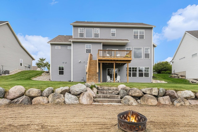 1506 Providence Cove Ct, Byron Center, MI 49315 - back of house with an outdoor fire pit, a deck, a yard, and central air condition unit