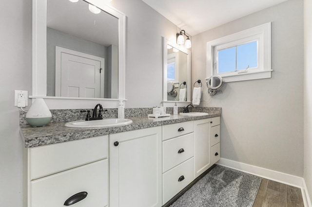 1506 Providence Cove Ct, Byron Center, MI 49315 - bathroom with double vanity, baseboards, and wood finished floors