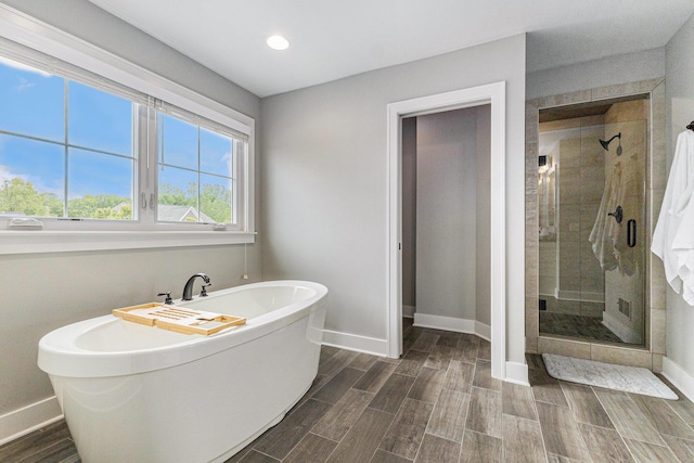 1506 Providence Cove Ct, Byron Center, MI 49315 - bathroom featuring baseboards, a soaking tub, a shower stall, wood finish floors, and recessed lighting