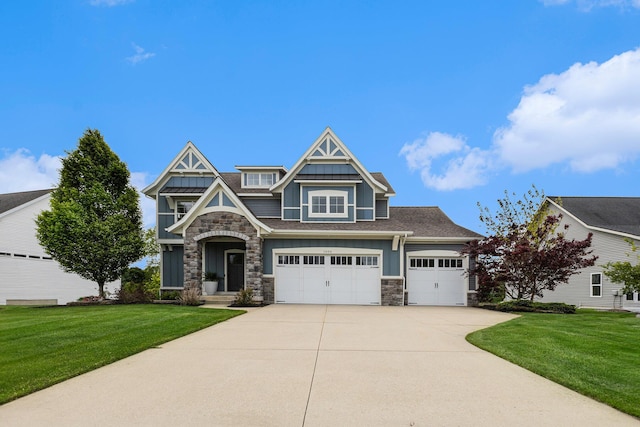 1506 Providence Cove Ct, Byron Center, MI 49315 - view of front of home featuring stone siding, concrete driveway, a front lawn, and board and batten siding